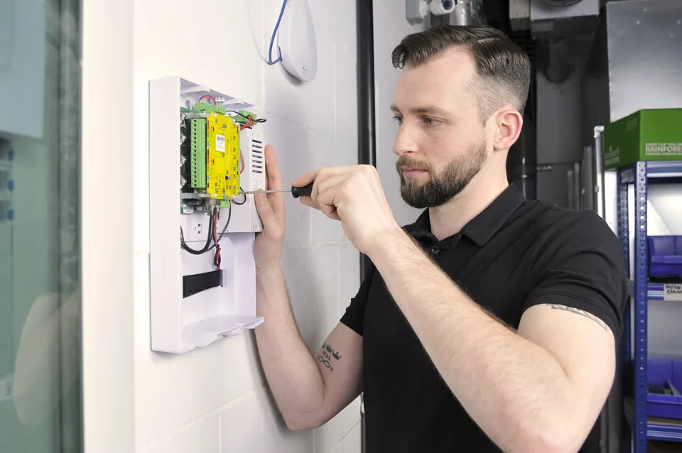 Engineer working on a Paxton access control panel